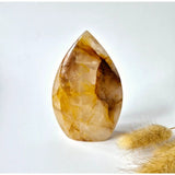 Golden Healer crystal drop, teardrop-shaped standing quartz with golden yellow and white bands.