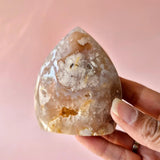 Moonlight Gemstones Druzy Roze Amethist freeform crystal with pale pink druse, held in hand