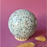 Kiwi Jasper ball, speckled white with black spots, 100 mm diameter.