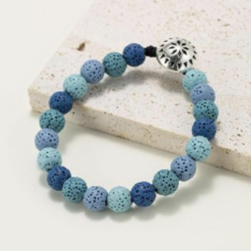 Ronde kralenarmbanden in natuurlijke lavasteen getint met blauwtinten