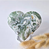 Giant moss agate drusy heart on metal stand with circular base; green and white patterned gemstone