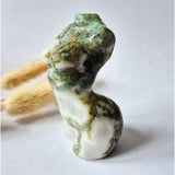 Moss agate female statue 8 cm; Moonlight Gemstones hand-carved sculpture of a stylized female figure.
