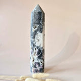 Moonlight Gemstones XL Lepidolite in quartz with tourmaline tower, gray-white with pink inclusions.