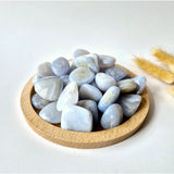 Blue lace agate palm stones, tumbled, 3 cm each, in a round wooden dish