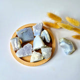 Blue lace agate rough druzy stones from Moonlight Gemstones, multiple pieces on a wooden board