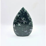 Druzy moss agate teardrop gemstone on stand with green crystalline surface.
