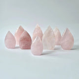 Nine flame-shaped rose quartz teardrop crystals, polished pink points for display