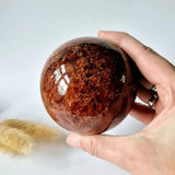 Strawberry quartz crystal sphere, 60mm, polished reddish-brown, Moonlight Gemstones