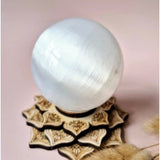 Pale blue-white selenite crystal sphere 80mm on a carved wooden stand, Moonlight Gemstones