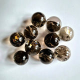 Smoky quartz crystal spheres with rainbow iridescence, 12-piece set.