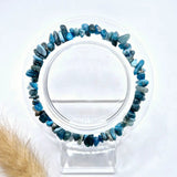 Blue apatite chip bracelet, 19 cm, displayed on a clear stand.